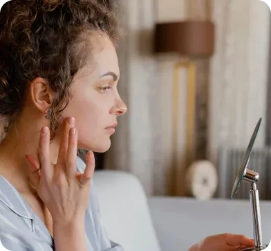 Patient applying skincare treatment at home