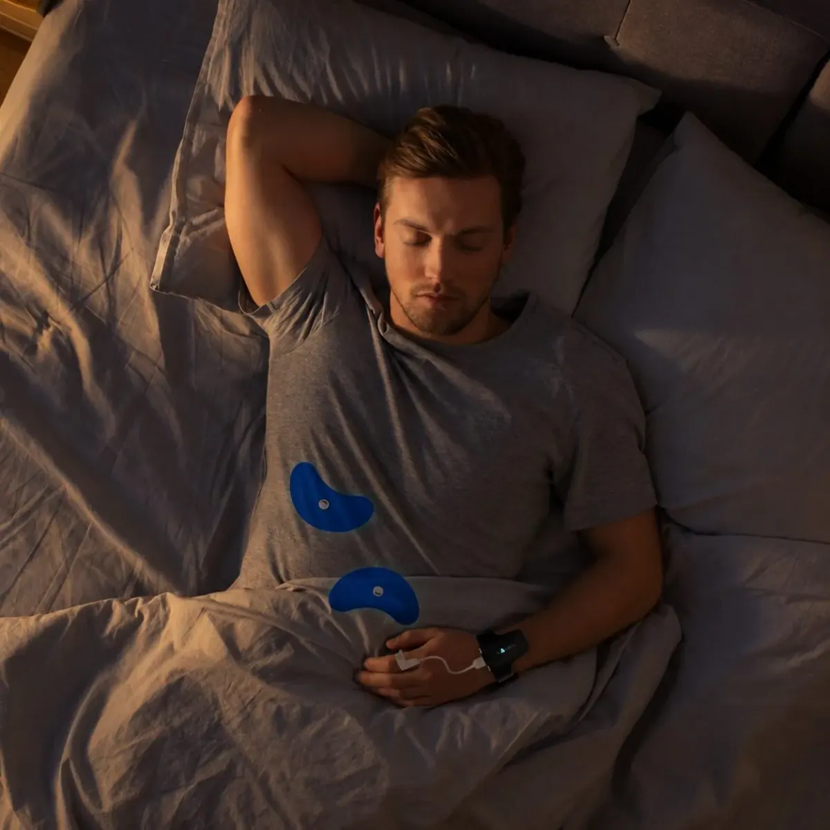 A person sleeping at home while wearing the Wesper home sleep test sensors
