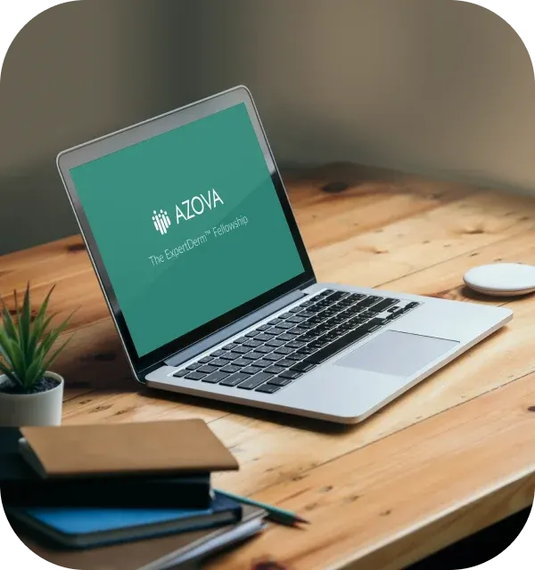 A laptop on a desk showing the AZOVA ExpertDerm Fellowship welcome screen