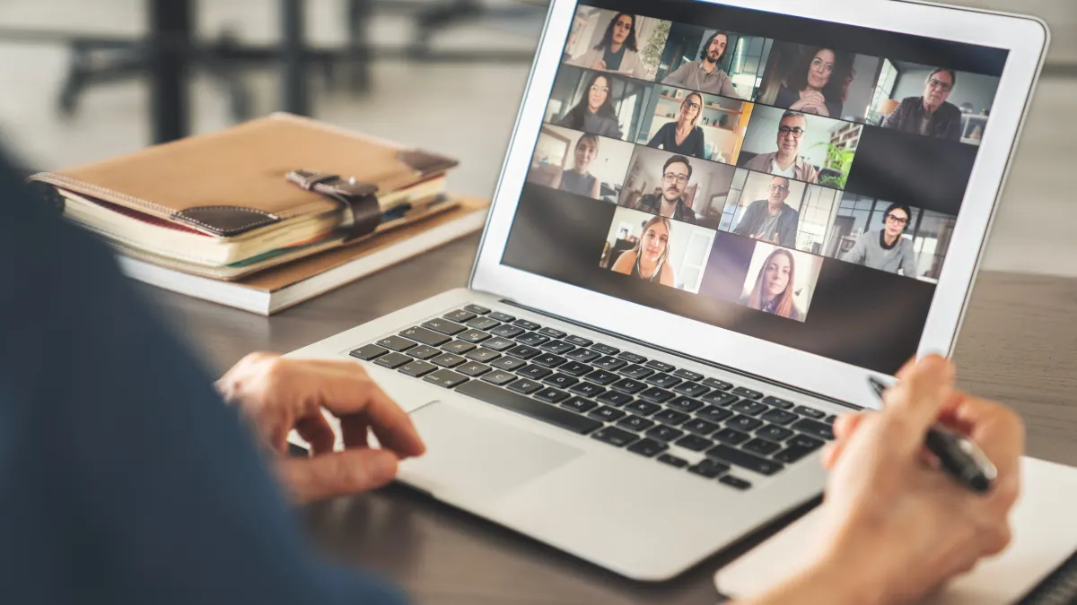 A person at home reviewing their personalized nutrition plan on a laptop during a video call with their functional nutritionist